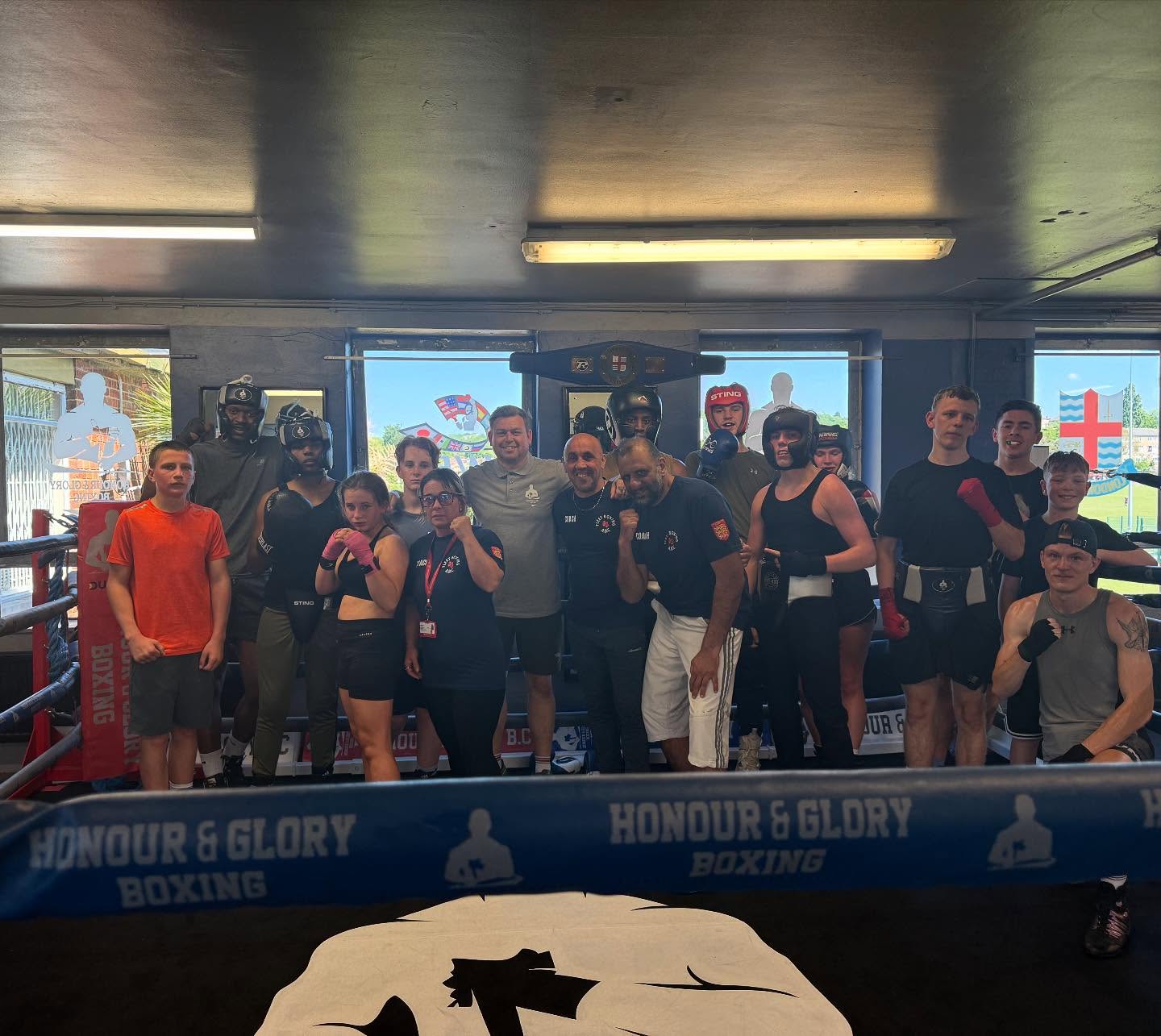 Full team photo with coaches and fighters